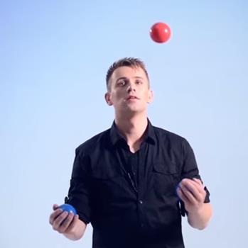 person juggling 3 balls